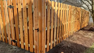 Cedar picket fence with a matching gate and black latch in Buffalo Grove